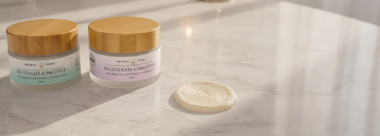 Two glass jars of beef tallow skincare placed on a table, one with a visible fingerprint mark, reflecting real-world use and precise formulation.